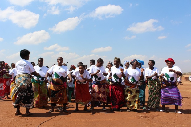 A women's group dancing and singing. 